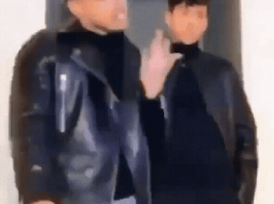 Two Men in Leather Jackets Talking