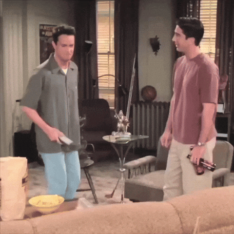 Two Men In Living Room With Army Poster GIF