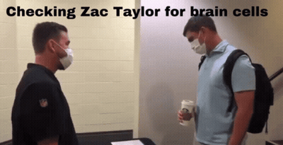 Two Men In Masks Checking Zac Taylor For Brain Cells GIF