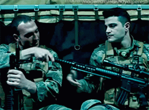 Two Men In Military Uniforms Are Holding Guns And One Has The Word Modern On His Back GIF
