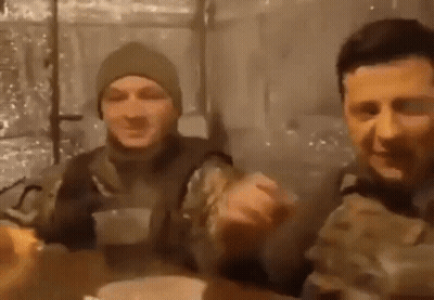 Two Men In Military Uniforms Are Sitting At A Table And Eating Food . GIF