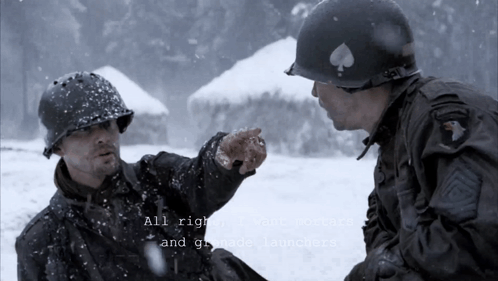 Two Men In Military Uniforms Are Talking In The Snow GIF
