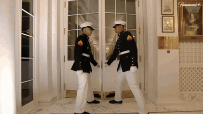 Two Men In Military Uniforms By Paramount Door GIF