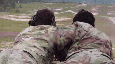 Two Men In Military Uniforms Lying In Field GIF