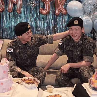 Two Men In Military Uniforms Sitting On Couch One With Number 8 On Sleeve GIF