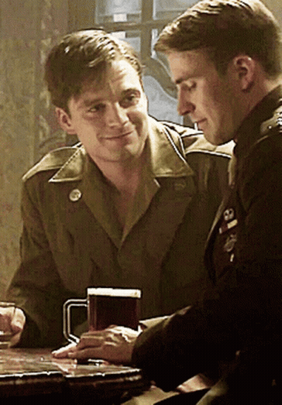 Two Men In Military Uniforms Sitting With Beer GIF