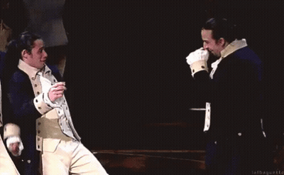 Two Men In Military Uniforms Smiling On Stage GIF