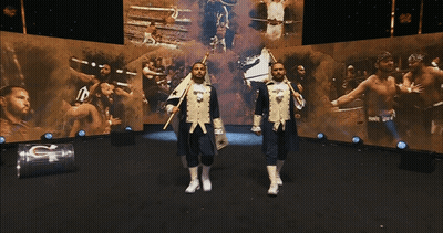 Two Men In Military Uniforms Stand In Front Of A Large Screen That Says G On It GIF