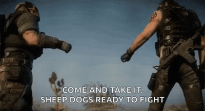 Two Men In Military Uniforms Standing In Desert GIF