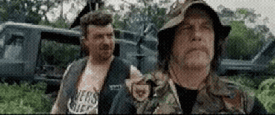 Two Men In Military Uniforms Standing In Field GIF