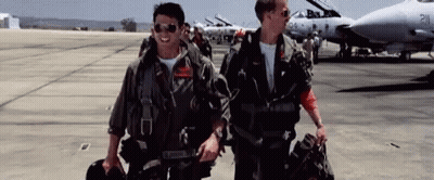 Two Men In Military Uniforms Walking On Runway In Front Of Jet GIF