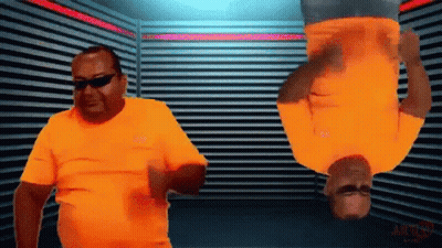 Two Men In Orange Shirts Are Upside Down In A Room With A Sign That Says Action GIF