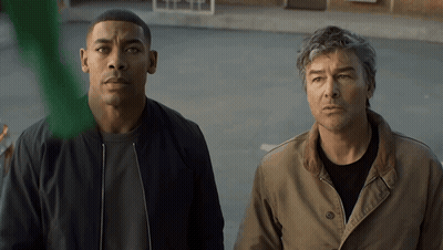Two Men In Parking Lot Looking At Something GIF