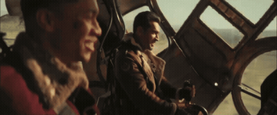 Two Men In Plane With Hotdog GIF