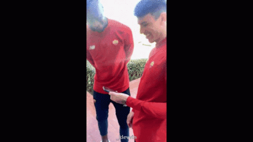 Two Men In Red Shirts Standing GIF