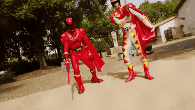 Two Men In Red Superhero Costumes GIF