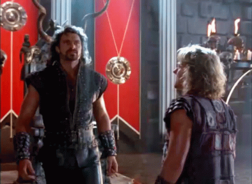 Two Men In Room With Red Wall GIF
