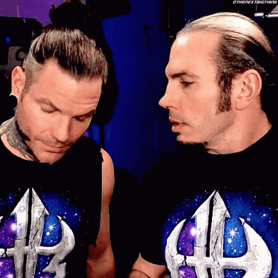 Two Men In Shirts With Letter H Looking At Each Other GIF
