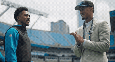 Two Men In Stadium One Wearing NFL Jersey GIF