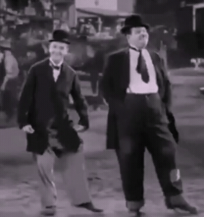 Two Men In Suits And Hats Are Dancing In A Black And White Photo GIF