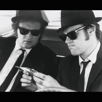 Two Men In Suits And Hats Are Playing Cards GIF