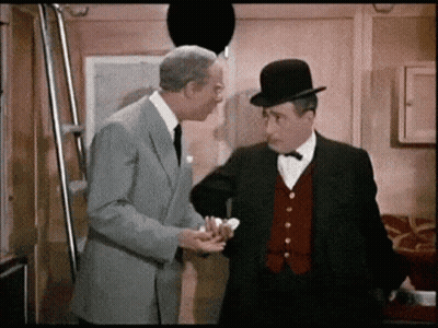Two Men In Suits And Hats Are Standing Next To Each Other And Talking GIF