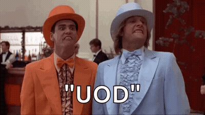 two men in suits and hats are standing next to each other in a room and saying uod .