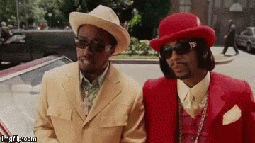 Two Men In Suits And Hats Are Standing Next To Each Other On The Street . GIF