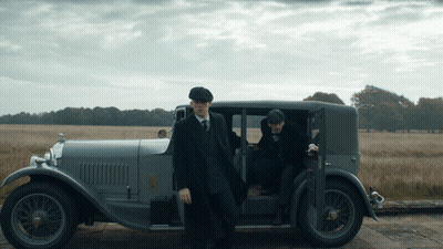 Two Men In Suits And Hats Getting Out Of Gray Car GIF