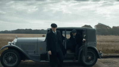 Two Men In Suits And Hats Standing Next To Car GIF