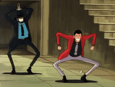 Two Men In Suits And Ties Are Dancing On The Street GIF