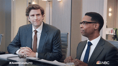 Two Men In Suits And Ties Are Sitting At A Table With A Nbc Logo On The Bottom GIF