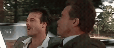 Two Men In Suits And Ties Are Sitting In A Car And Talking To Each Other . GIF