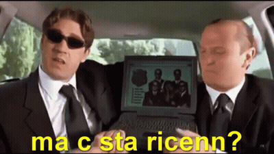 Two Men In Suits And Ties Are Sitting In A Car Looking At A Laptop Screen That Says Ma C Sta Ricenn? GIF