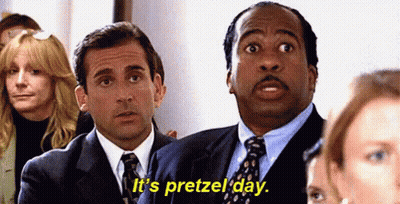 Two Men In Suits And Ties Are Sitting In Front Of A Crowd Of People . GIF