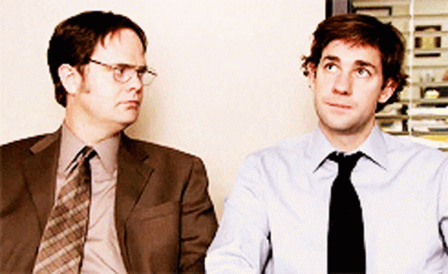 Two Men In Suits And Ties Are Sitting Next To Each Other And Looking Up GIF