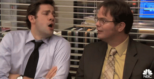 Two Men In Suits And Ties Are Sitting Next To Each Other In An Office . GIF