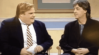 Two Men In Suits And Ties Are Sitting Next To Each Other In Chairs And Talking . GIF