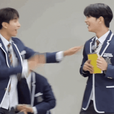 Two Men In Suits And Ties Are Standing Next To Each Other . GIF