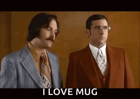 Two Men In Suits And Ties Are Standing Next To Each Other And One Of Them Is Holding A Mug . GIF