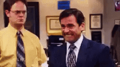 Two Men In Suits And Ties Are Standing Next To Each Other In A Room . GIF