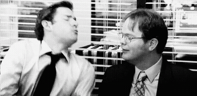 Two Men In Suits And Ties Are Standing Next To Each Other In An Office . GIF