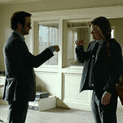 Two Men In Suits And Ties Are Standing Next To Each Other Talking GIF