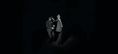 Two Men In Suits And Ties Are Standing Next To Each Other With Their Arms Outstretched . GIF