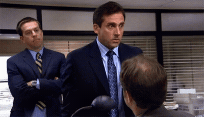 Two Men In Suits And Ties Are Talking To Each Other In An Office . GIF