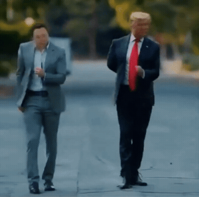 Two Men In Suits And Ties Are Walking Down The Street . GIF