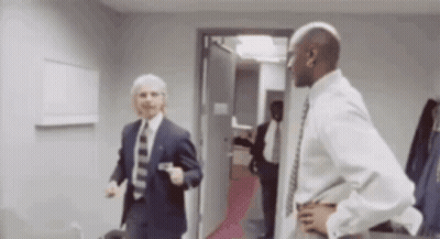 Two Men In Suits And Ties Blurry GIF