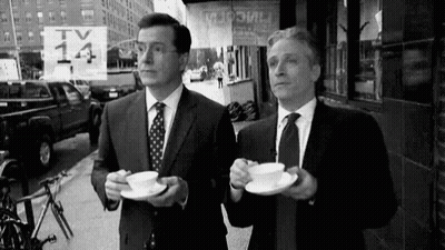 Two Men In Suits And Ties Drinking Coffee GIF
