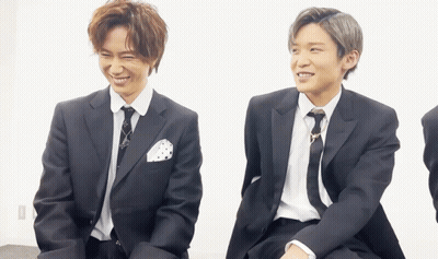 Two Men In Suits And Ties Sitting Together GIF