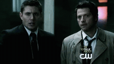 Two Men In Suits And Ties Standing Together GIF